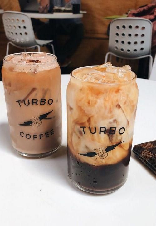 two iced drinks sitting on top of a white table