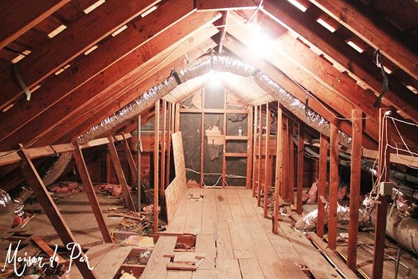 an attic with wood flooring and exposed rafters on the ceiling is being remodeled