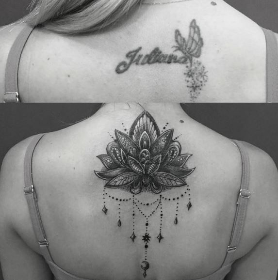 the back of a woman's neck with tattoos on it and an image of a lotus