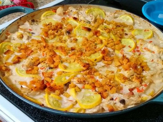 a pan filled with food sitting on top of a stove next to two blue dishes