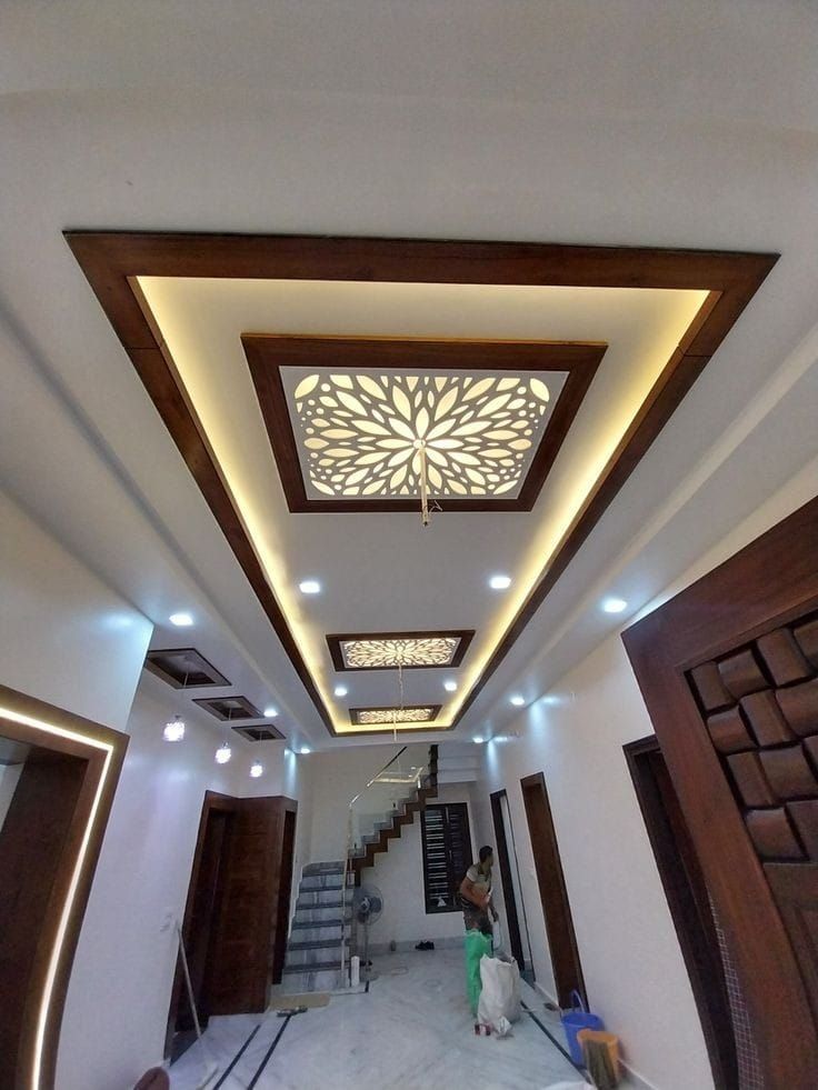 the inside of a house with some lights and wood trimmings on the ceiling