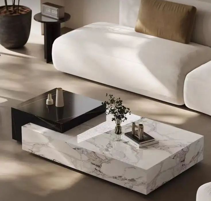 a marble coffee table sitting on top of a hard wood floor next to a couch