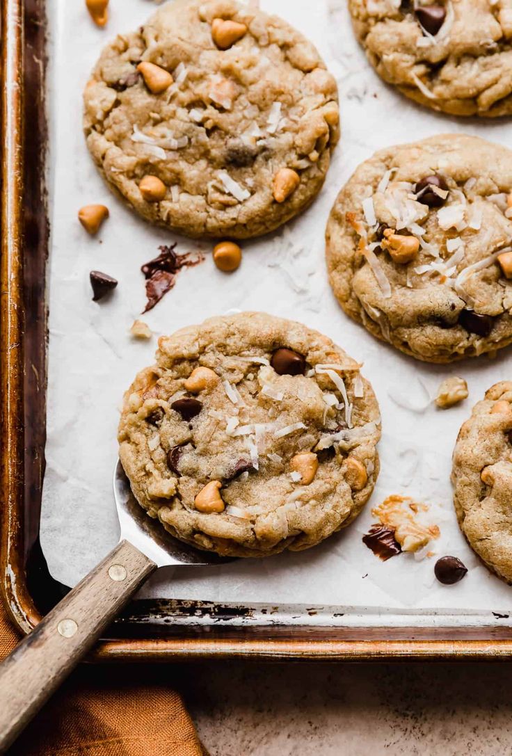 chocolate chip cookies with nuts and coconut on a baking sheet