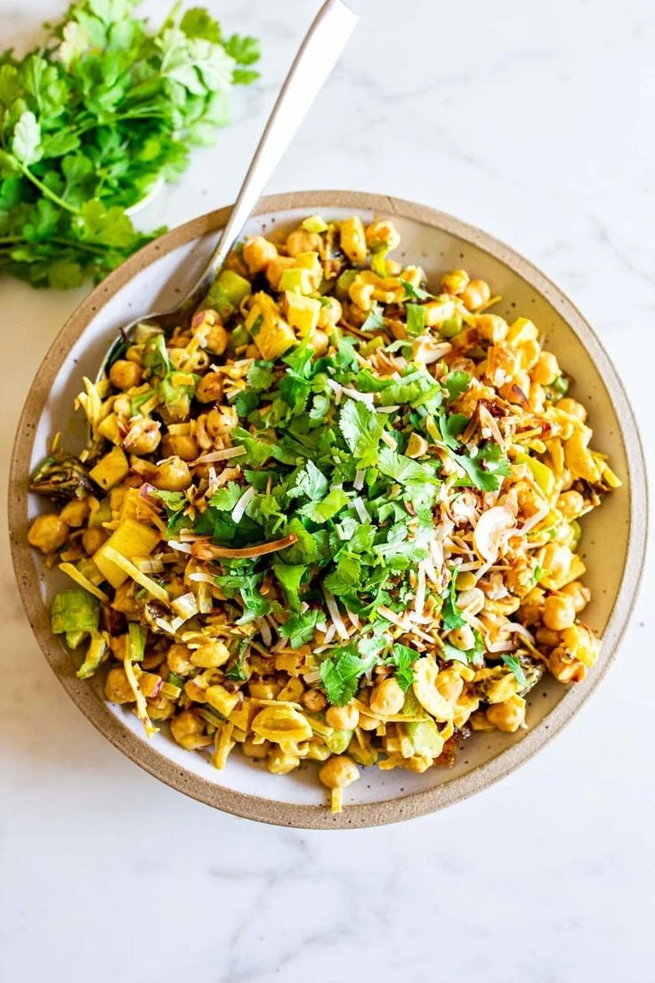 a white bowl filled with corn and greens