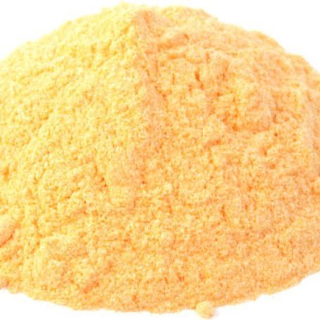 a pile of yellow powder on a white background