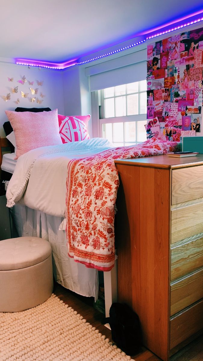 a bedroom with pink and white decor on the walls