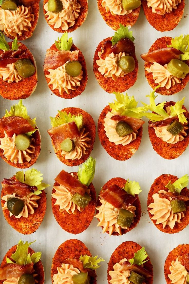 small appetizers are arranged on a white surface