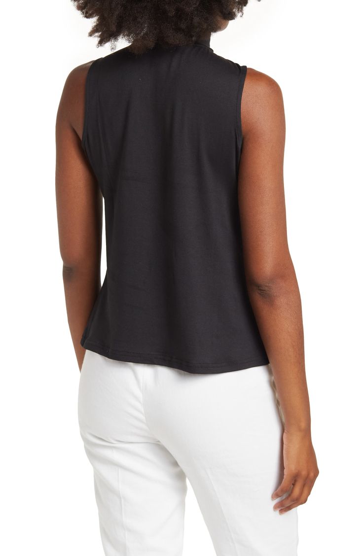 This super chic mock-neck sleeveless blouse is the perfect top whether it's in the office or out on the town. 25" length (size L) Mock neck Sleeveless Slips on over the head 95% polyester, 5% spandex Machine wash cold, tumble dry low Model Stats: 5'10" height; 34" bust; 27" waist; 35" hips. Model is wearing size L. Elegant Sleeveless Mock Neck Top For Spring, Chic Sleeveless Mock Neck Top For Summer, Spring High Neck Tank Top For Work, Spring Workwear High Neck Tank Top, Casual Sleeveless Mock Neck Top For Work, Chic Sleeveless Mock Neck Top For Work, Versatile Sleeveless Mock Neck Top For Spring, High Neck Summer Workwear Tops, Casual Sleeveless Mock Neck Top