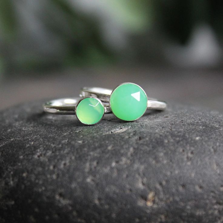 This stone is such a pretty shade of green! Chrysoprase is the gemstone for the broken hearted...who knew? This ring has a sturdy ring band with a 6mm or 8mm rose cut chrysoprase cabochon set in a sterling silver bezel. It can be worn with other stackable rings, or by itself. Handmade by Barb Macy in Corvallis, OR. Handmade Green Stackable Rings For Gift, Adjustable Green Opal Ring, Green Stackable Rings For May Birthstone, Adjustable Green Opal Ring Gift, Handmade Green Stackable Rings For May Birthstone, Green Minimalist Stackable Rings With Bezel Setting, Minimalist Green Stackable Rings With Bezel Setting, Green Stackable Rings For Gift, Green Stackable May Birthstone Rings As A Gift