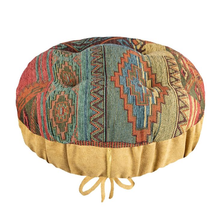 a multicolored round cushion with ties around the edges and an intricate design on top