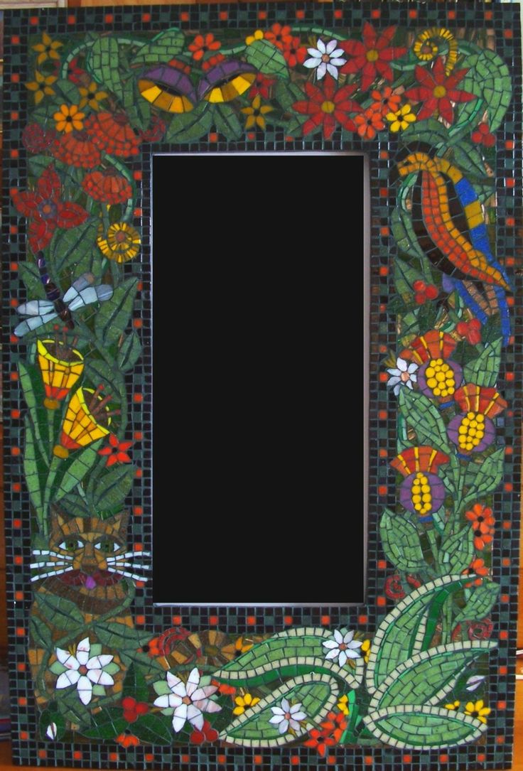 a mosaic frame with flowers and birds on it