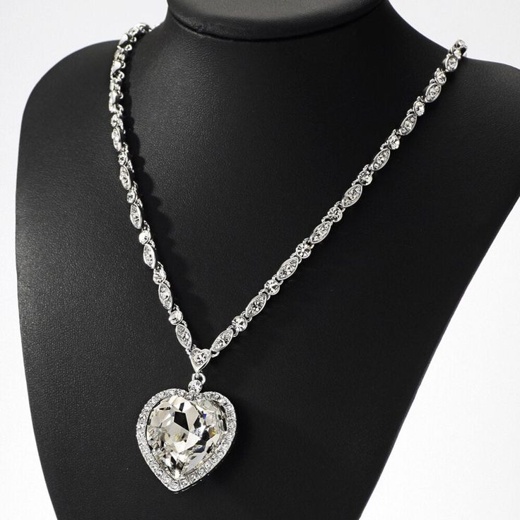 This high quality sterling silver Italian made chain features diamond cut moon shape cuts into the beads. This incredible detailing gives you a unique sparkle and shine once the light hits the chain. Its a small 2mm size chain that's good for mini or micro pendants. This chain is rhodium plated and gives you the exact look and feel of a white gold chain. Precious shiny added thanks to the round stone and the following 16x16mm heart cut moissonite below 925 Sterling Silver (Rhodium Plated) 2mm Wi Silver Crystal Heart Necklace For Wedding, Crystal Heart Cut Jewelry With Heart Charm, Heart Pendant Diamond Jewelry For Party, Diamond Heart Pendant Jewelry For Party, Diamond Heart Pendant For Party, Elegant Heart Pendant Jewelry With Bling, Elegant Bling Heart Pendant Jewelry, Heart-shaped Chain Jewelry For Weddings, Elegant Heart-shaped Bling Jewelry