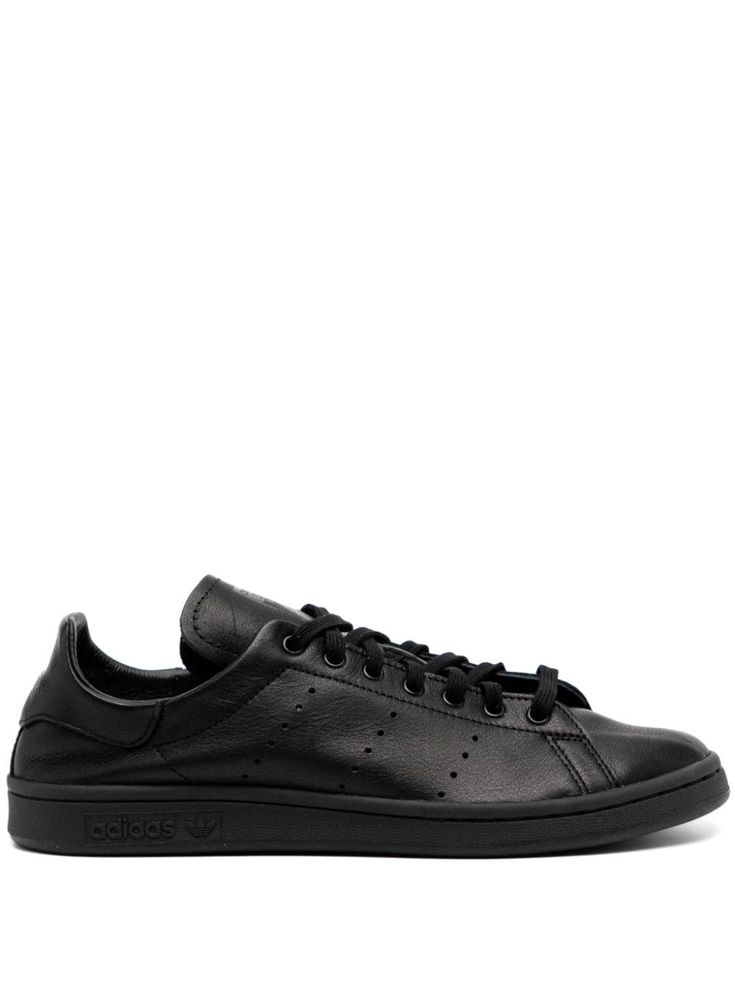 black leather perforated logo detail front lace-up fastening eyelet detailing logo-print tongue round toe branded insole flat rubber sole Custom Adidas Leather Sneakers With Laces, Classic Adidas Sneakers With Rubber Sole, Leather Sneakers With Studded Rubber Outsoles For Streetwear, Adidas Custom Leather Sneakers With Laces, Custom Leather Sneakers With Laces For Streetwear, Leather Custom Sneakers With Laces For Streetwear, Classic High-top Synthetic Sneakers With Laces, Adidas Sporty Sneakers With Embossed Logo, Adidas Classic Low-top Custom Sneakers