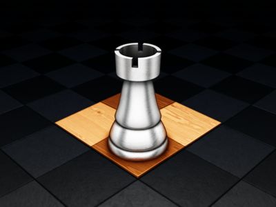 a metal chess piece sitting on top of a wooden board