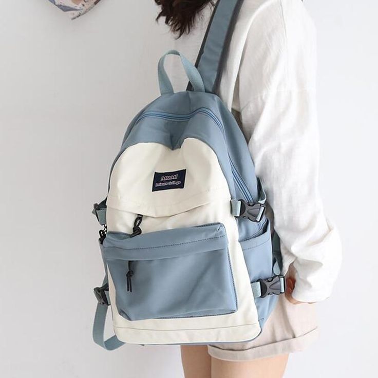 Made from a high-quality material, the backpack has a colored front and side pockets, perfect for college and all occasions when you need a simple yet stylish bag. Striking design in comfy water resistant material. This bag has multiple zipped pockets & features comfy soft non-slip straps and carry handle. Plenty of space for your phone, work items and your tablet. Classic look, sleek and fashionable! You’ll feel smart when out and about, and yet this bag is made for your comfort. It comes in 4 Cute Backpacks For School, Cute School Bags, Stylish School Bags, Women Backpack Fashion, Student Book, Girl Backpacks School, Book Bags, Backpack Fashion, Unisex Backpack