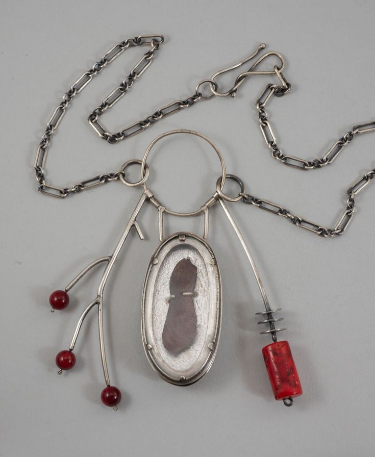 A talisman necklace with its central element being an elm tree seed set behind glass as a sort of biological specimen. One side resembles a branch with three red buds and the other side has a more primitive with its coral bead and silver discs. Elm Tree, Red Bud, Talisman Jewelry, Talisman Necklace, Unusual Jewelry, Coral Beads, Metal Jewelry, Pendant Necklaces, Handcrafted Jewelry