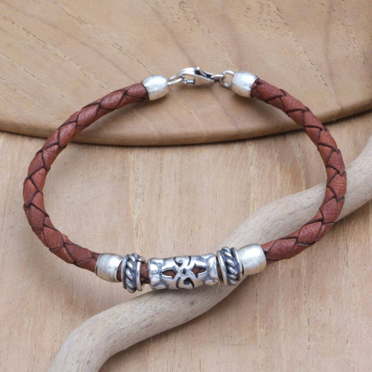 A charming pendant embellishes this braided bracelet, handcrafted from brown leather by Balinese artisan Cahya Krisna. With a combination finish beautifying the design, this lovely accessory is ready to add a unique accent to your outfits. Bohemian Leather Braided Bracelet As Gift, Nickel-free Brown Bracelets As Gift, Nickel-free Brown Bracelets For Gifts, Everyday Brown Leather Strap Jewelry, Brown Braided Leather Bracelet In Bohemian Style, Adjustable Braided Brown Jewelry, Adjustable Brown Braided Jewelry, Brown Braided Bracelets For Everyday, Everyday Brown Braided Bracelets