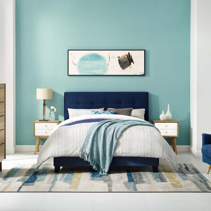 a bedroom with blue walls and furniture