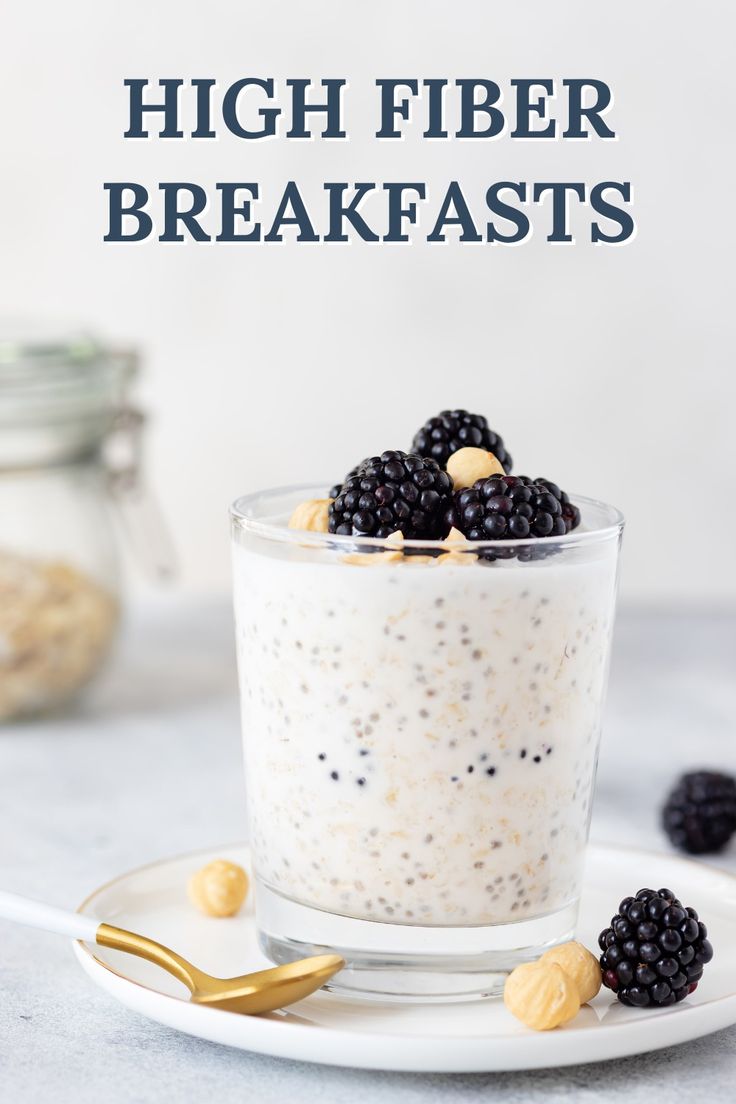 an image of high fiber breakfasts in a glass with berries and nuts on the side