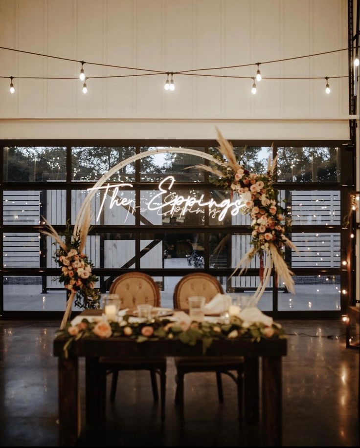 a table with two chairs and a sign that says the empire on it in front of a window