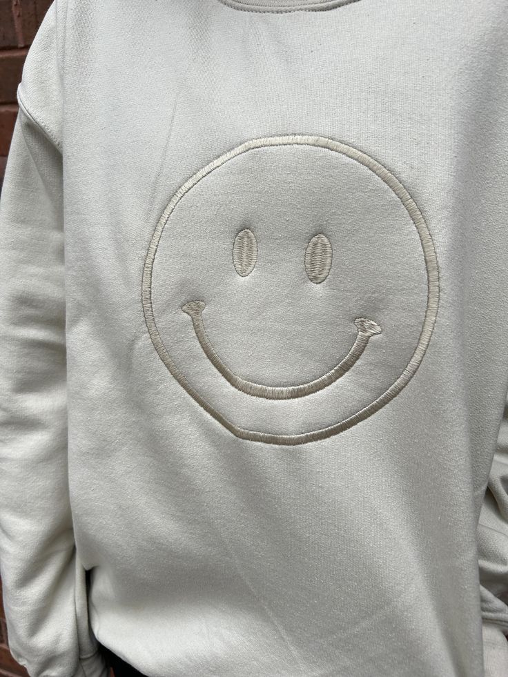 Spread all the smiles! And be on Trend with this gorgeous monochromatic KIKI crew sweatshirt featuring an embroidered smiley face graphic on the front. She is very Cozy and comfy and such a great way to brighten the day of all of the people around you! 50% Polyester 50% Cotton Fits true to size Model is 5'2" with a 25" waist, 31" hips and a 32" Bust and is wearing a small. Embroidered Smiley Face, Smiley Face Graphic, Face Graphic, Shoe Gifts, Going Back To School, All Smiles, Crew Sweatshirts, Smiley Face, Smiley