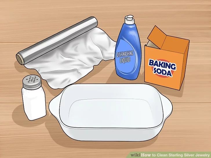 baking supplies on a wooden surface including baking soda, baking pan and baking soap bottle