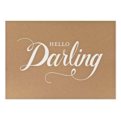 a brown greeting card with the words hello darling on it in white lettering, against a beige background