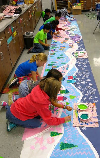 children are painting on the floor in an art class