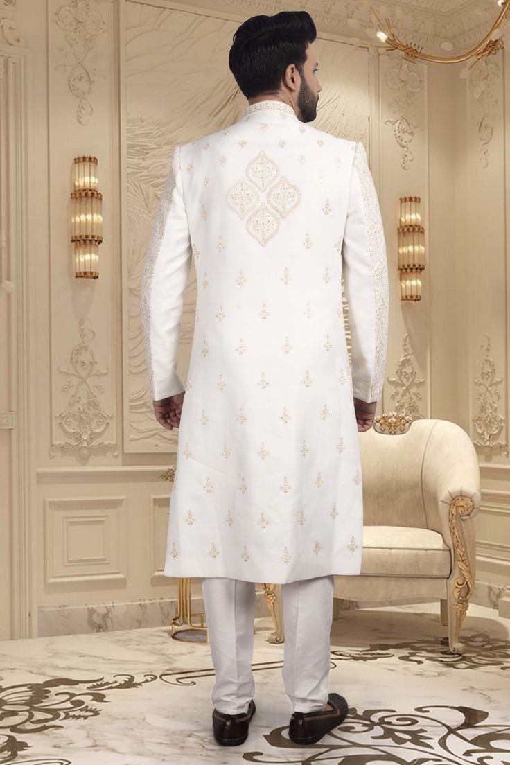 Make a grand entrance with our Mens Sherwani- U2-S342, the perfect choice for the stylish groom. The exquisite thread and stone embroidery adds a touch of royalty to this traditional garment. Walk down the aisle in style and make a statement with this sophisticated and exclusive piece. Bollywood Style Sherwani With Dabka In Traditional Fit, White Dabka Sherwani Traditional Fit, Bollywood Style Ceremonial Sherwani With Traditional Fit, Traditional Fit Sherwani For Wedding And Diwali, Traditional Fit Bandhgala For Wedding, Wedding Sherwani For Diwali, Embroidered Traditional Fit Sherwani For Wedding, Elegant Traditional Fit Sherwani For Festive Occasions, Traditional Fit Sherwani For Eid Wedding