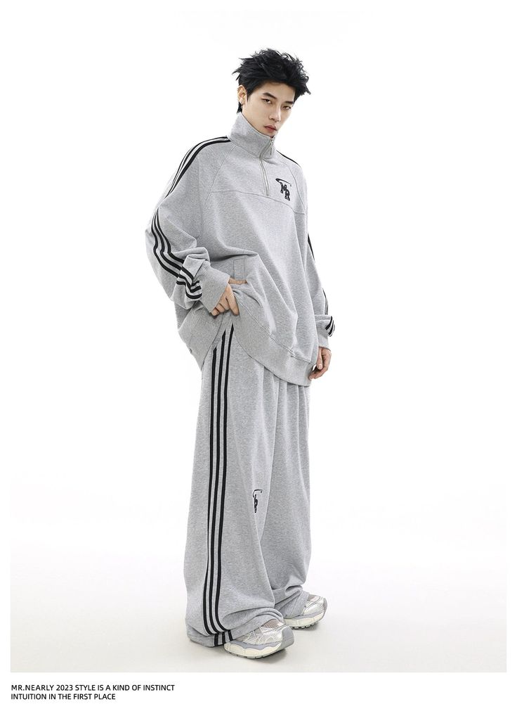 The "Urban Edge Athleisure Set" offers a stylish blend of comfort and street style. Featuring a soft grey zip-up jacket with a subtle chest emblem and matching drawstring pants with sleek side stripes. This tracksuit is perfect for versatile, everyday wear. Wide Leg Track Pants, Grey Top, Side Stripe, Cotton Jacket, Drawstring Pants, Cotton Pants, Track Jackets, Half Zip, Zip Up