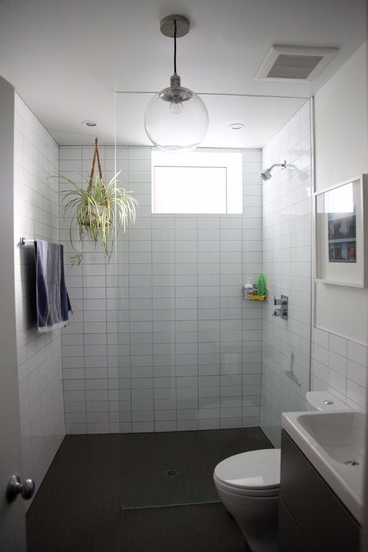 a bathroom with a toilet, sink and shower