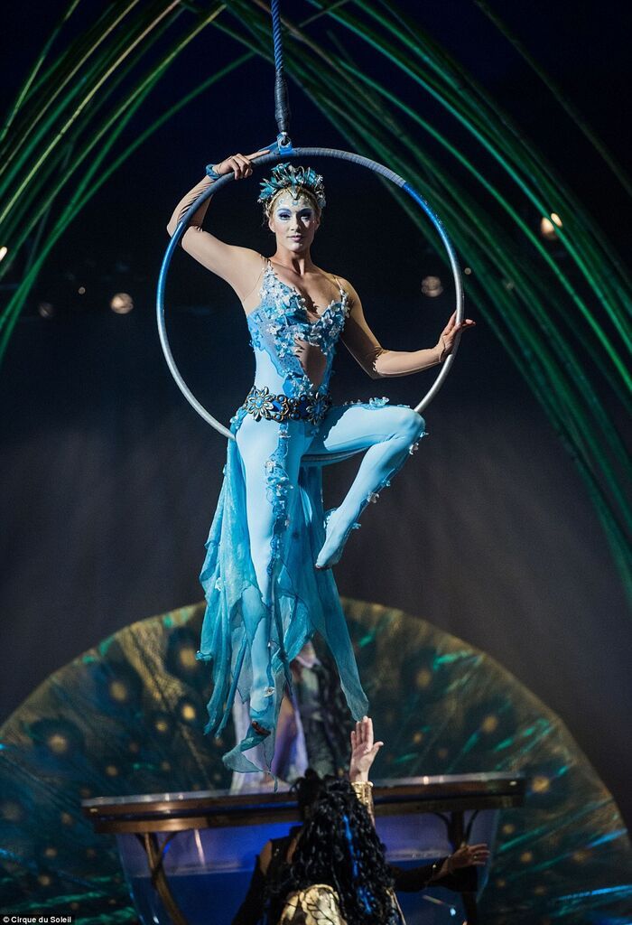 a woman in a blue dress holding a hoop