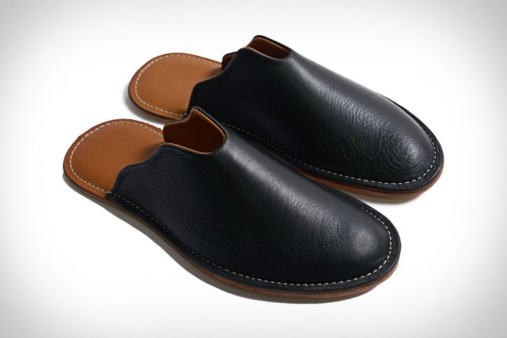 You might be grumpy, but your feet won't be in these cushioned leather slippers. The classic style features a leather lining with a comfortable cushioned... Comfortable Leather Slip-ons With Cushioned Footbed, Casual Slip-on Slippers With Leather Lining, Classic Mules With Stitched Sole And Plain Toe, Classic Slippers With Rubber Sole And Flat Heel, Leather Slippers With Cushioned Footbed And Round Toe, Leather Slip-on Slippers With Cushioned Footbed, Comfortable Leather Shoes With Rubber Sole, Classic Leather Slippers With Round Toe, Leather Mules With Stitched Sole And Plain Toe