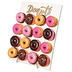 there are many donuts in the box and one is pink, brown and white