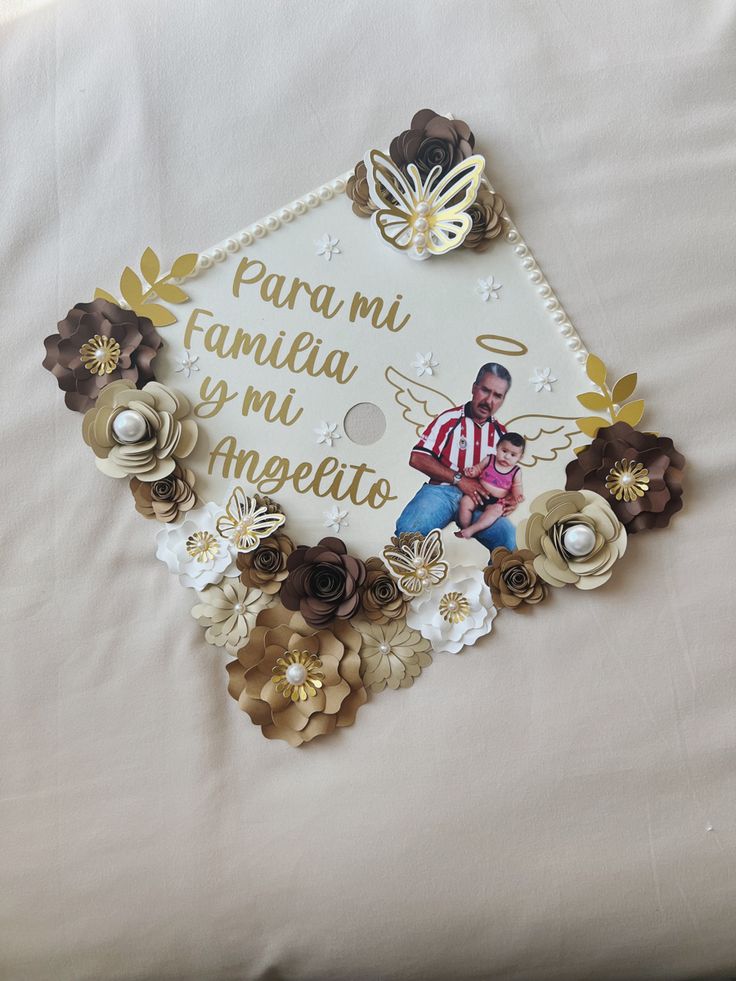 a graduation cap with flowers on it and a man in the center surrounded by words