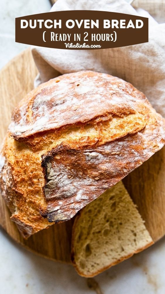 a loaf of bread sitting on top of a wooden cutting board