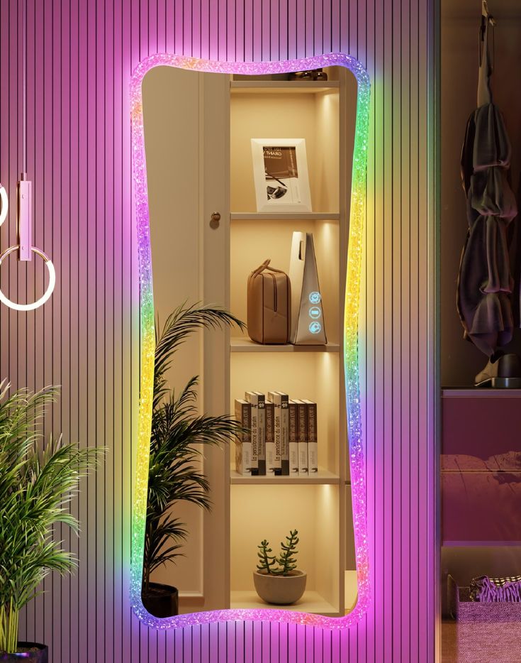 an illuminated shelf with books, plants and other items on it next to a potted plant