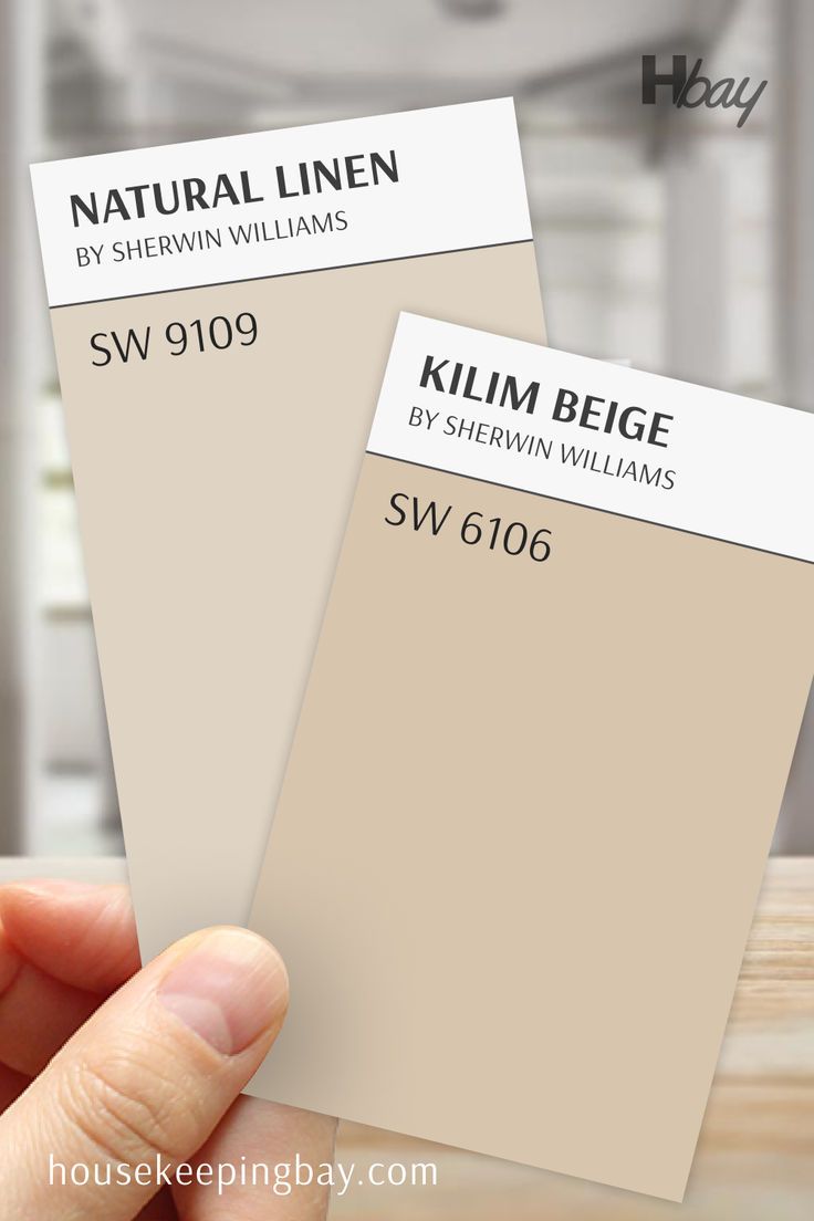 The image shows a comparison between two Sherwin Williams paint colors. On the left is "Natural Linen" (SW 9109), a soft beige with warm, creamy undertones. On the right is "Kilim Beige" (SW 6106), a slightly deeper, warmer beige with more pronounced tan undertones. Both samples are held by a hand against a blurred background, allowing a clear comparison of the subtle differences in warmth and depth between these two inviting neutral shades Kilim Beige Coordinating Colors, Yellow Paint Colors, Kilim Beige, Yellow Paint, Yellow Painting, Coordinating Colors, Sherwin Williams, Natural Linen, Light Beige