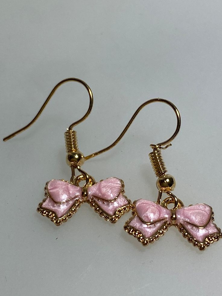 Beautiful earrings with enamel beads in bow shape (about 1 cm) in soft pink with gold-colored ear hooks. Dear customers, please do not take the jewelry in the shower or in the water. So that you can enjoy yourself for a long time. We are happy to send the jewel in a sweet gold or silver colored jewelry bag, please order a jewelry bag for this. In addition, we are happy to take over the shipment to another recipient - simply specify a different delivery address. There is also a small card - text Cute Pink Bow Jewelry For Gift, Cute Pink Bow Earrings As Gift, Feminine Pink Jewelry With Pink Bow, Pink Bow Earrings, Cute Pink Earrings With Pink Bow, Enamel Beads, Rose Pale, Bow Earrings, Girly Accessories