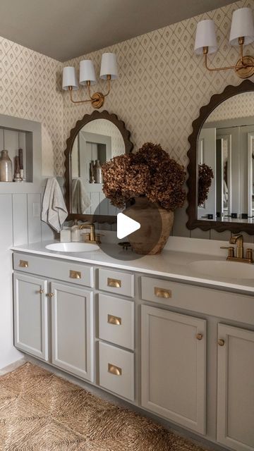 a bathroom with two sinks and mirrors on the wall