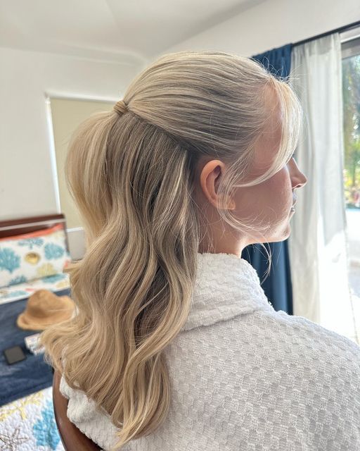 a woman with long blonde hair in a ponytail