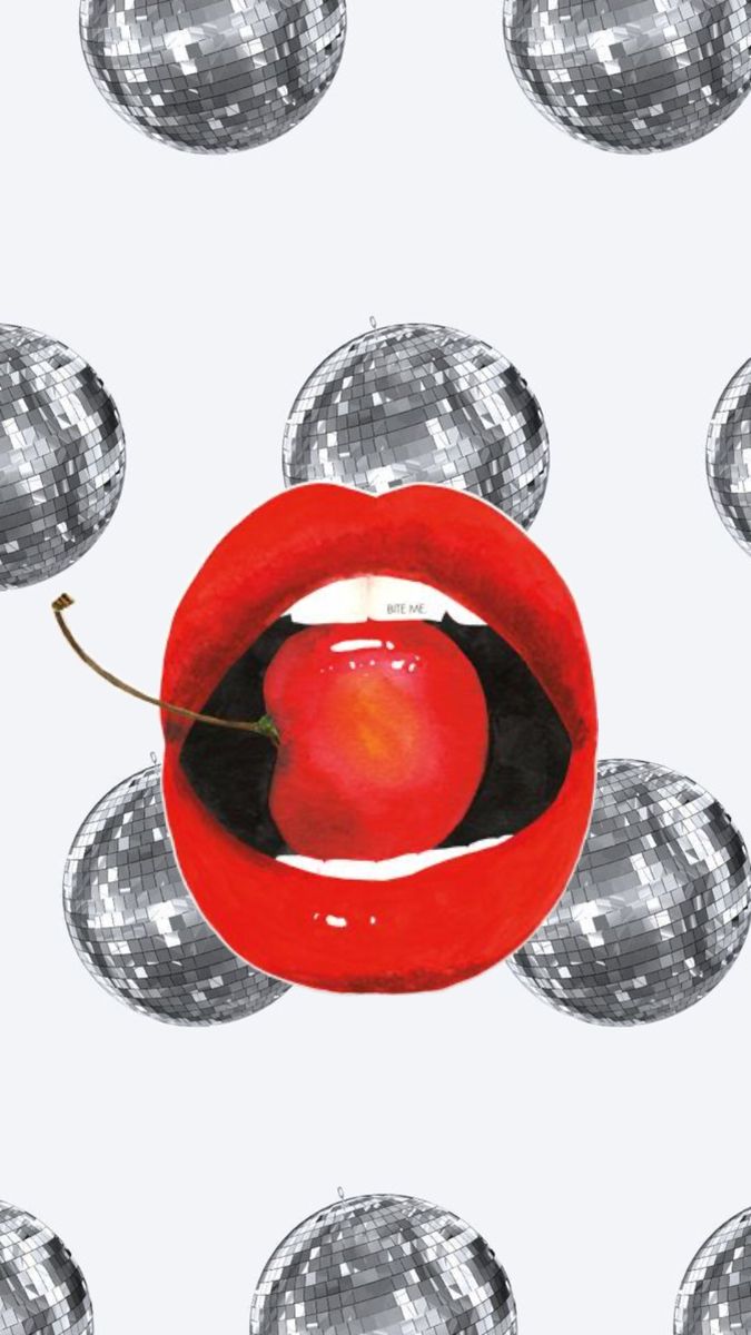 an apple in a red bowl surrounded by silver balls and disco ball magnets on a white background