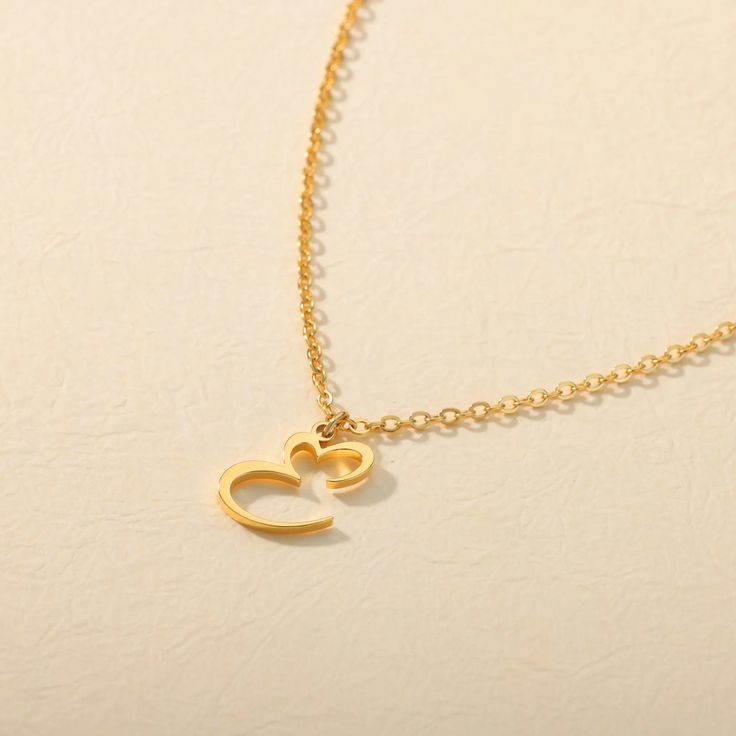 Introducing our Heart Initial Letter Necklace, a timeless and personalized piece of jewelry that beautifully captures the essence of love and individuality. This exquisite necklace features a delicate and intricately designed initial, with a charming heart delicately positioned beside it.Whether it's a gift for yourself or a loved one, the Heart Initial Letter Necklace is a cherished keepsake that symbolizes the profound connections we share with others. Wear your own initial or that of a specia Elegant Initial Necklace With Delicate Chain For Mother's Day, Elegant Mother's Day Initial Necklace With Delicate Chain, Elegant Personalized Heart Necklace For Valentine's Day, Elegant Heart Charm Name Necklace, Valentine's Day Heart Charm Initial Pendant Necklace, Elegant Initial Pendant Necklace For Valentine's Day, Elegant Double Heart Name Necklace With Charm, Elegant Personalized Heart Necklace With Round Pendant, Elegant Personalized Round Pendant Heart Necklace