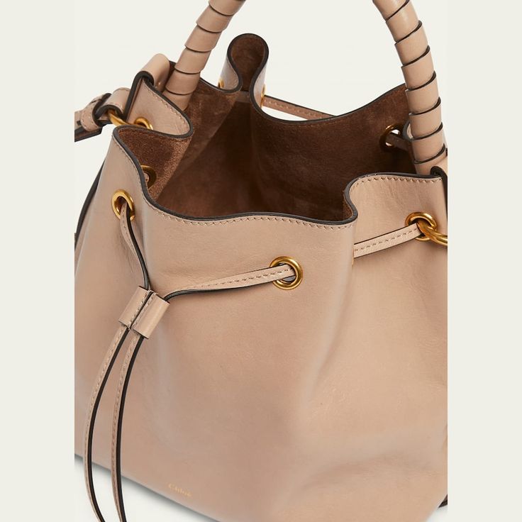 Chloe "Marcie" bucket bag in shiny calfskin  Rolled top handle  Adjustable crossbody strap Can be worn as a top handle or crossbody bag  Drawstring closure  Lining: Leather Approx. 9.4"H x 10.2"W x 5.9"D Made in Italy Calf Leather Bucket Shoulder Bag With Gold-tone Hardware, Calf Leather Bucket Bag With Adjustable Strap, Designer Bucket Satchel With Handle Drop, Designer Bucket Bag With Detachable Strap And Top Handle, Leather Bucket Bag With Round Handle, Designer Bucket Satchel With Detachable Handle, Designer Bucket Satchel With Detachable Strap, Luxury Crossbody Bucket Bag For Shopping, Luxury Bucket Satchel With Adjustable Strap