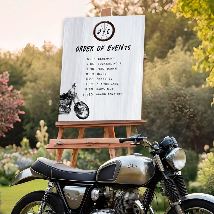 a motorcycle parked in front of an easel with a sign on it that says order of events