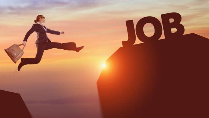 a man jumping over the word job on top of a cliff