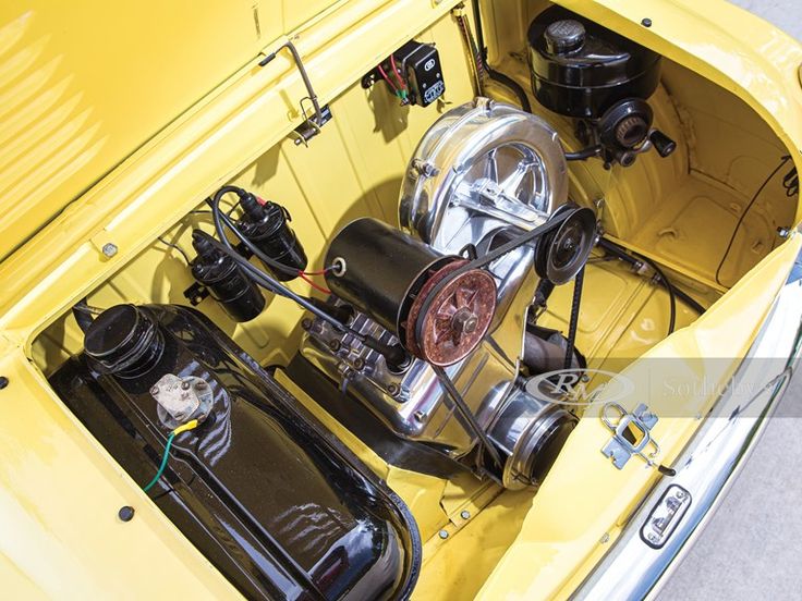 the engine compartment of an old yellow car