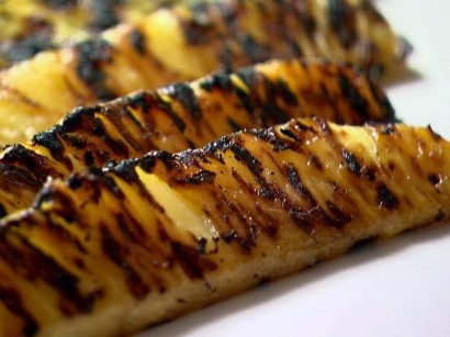 grilled bananas are sitting on a white plate