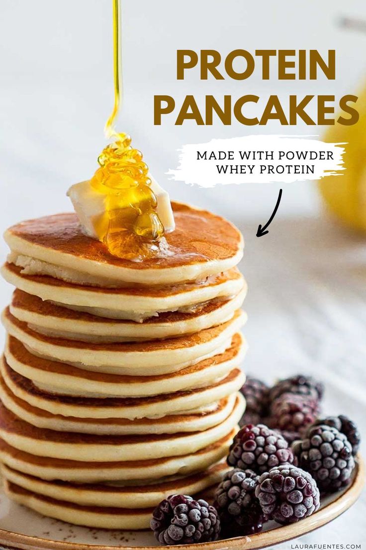 pancakes stacked on top of each other with syrup being drizzled over them