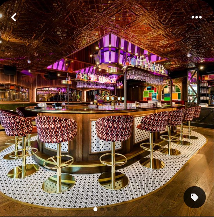 the interior of a bar with stools and barstools in front of it